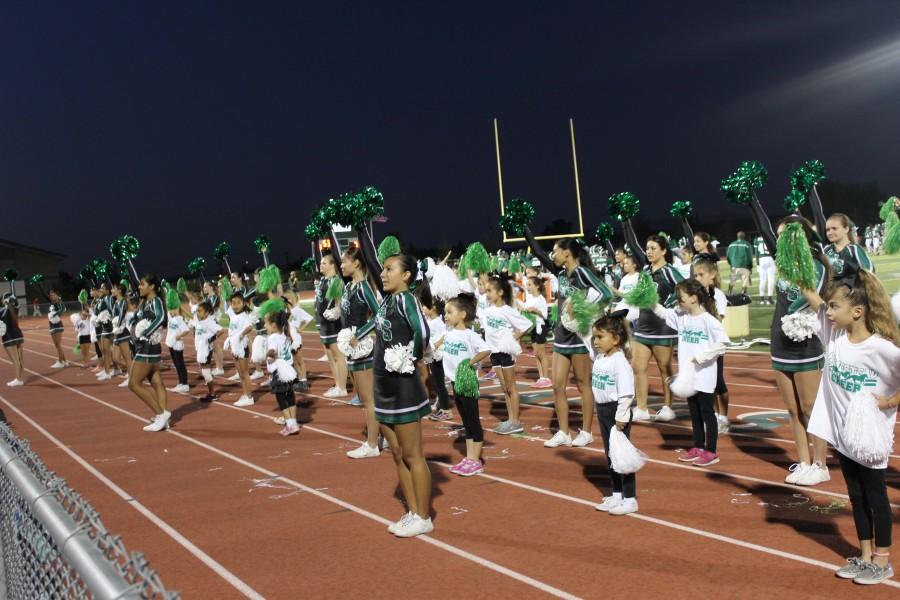 Campers join the Cheer team in leading the crowd at the Homestead vs. Leland football game last Friday.