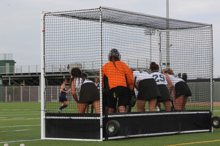 Members of the junior varsity field hockey team guard the goal in a game against Lynbrook