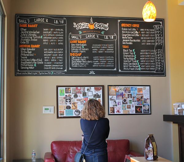 A patient customer browses the variety of organic roasts, teas, and specialty drinks on Philz’s menu.