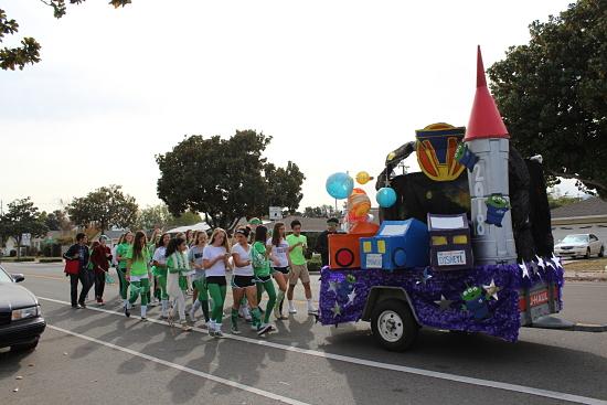 The sophomore class walks with their Tomorrowland float