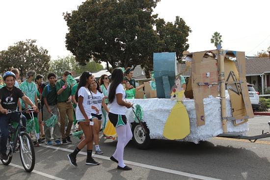 The senior class walks in their final parade with their Fanstasyland float