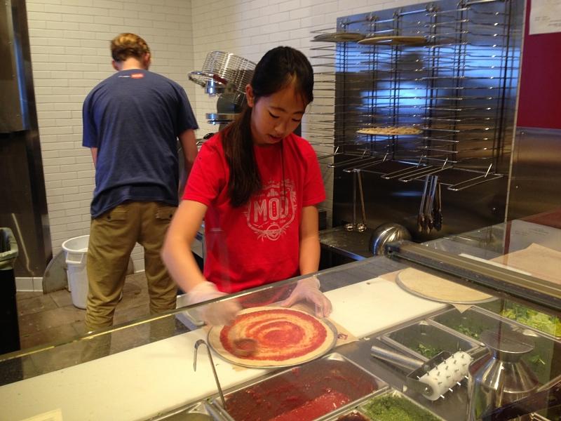 Senior Minhee Son's co-worker Nao Sugiyama makes personalized pizzas at MOD Pizza during her spare time in second semester.
