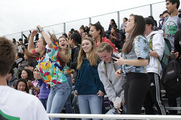 Students cheers on their favorite team in the stands.