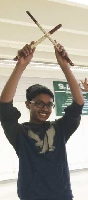 Raas captains dancing with traditional dandiya sticks.