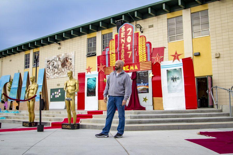 Principal Greg Giglio stands proudly in front of the Homecoming quad decorations, a culmination of student spirit and creativity.