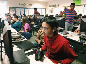 Programming members focus intently on completing their projects. 