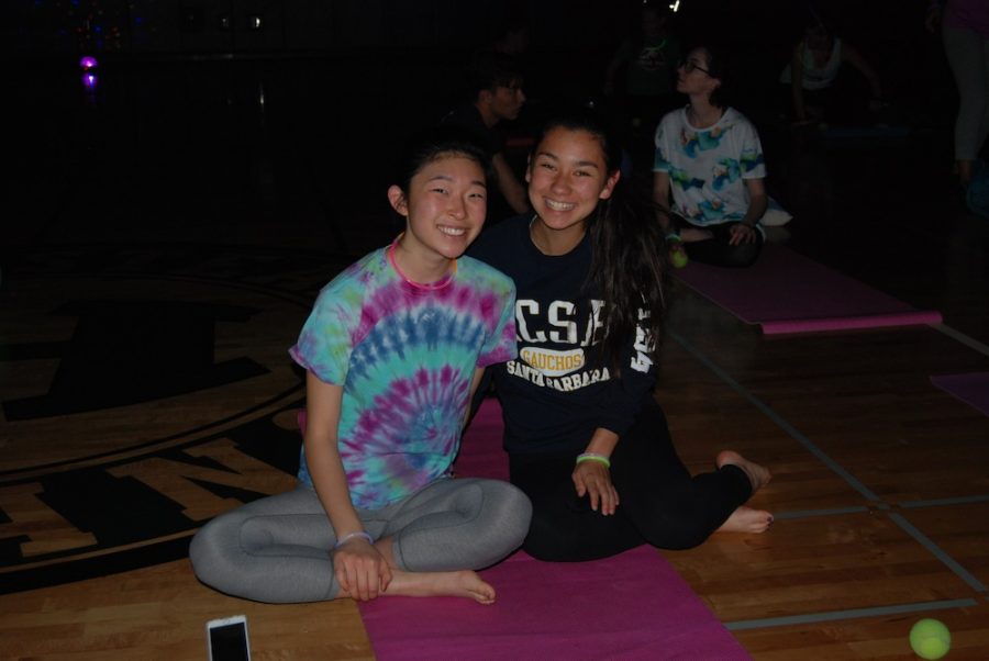 Students, faculty, and members of the community enjoy a stress relieving night with yoga in disco lights and glowsticks. 