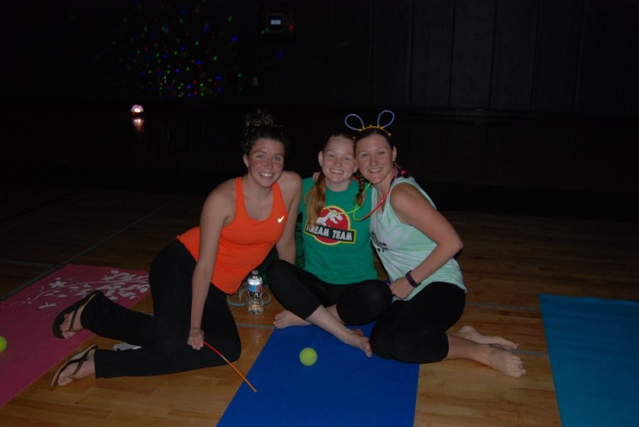 Students, faculty, and members of the community enjoy a stress relieving night with yoga in disco lights and glowsticks. 