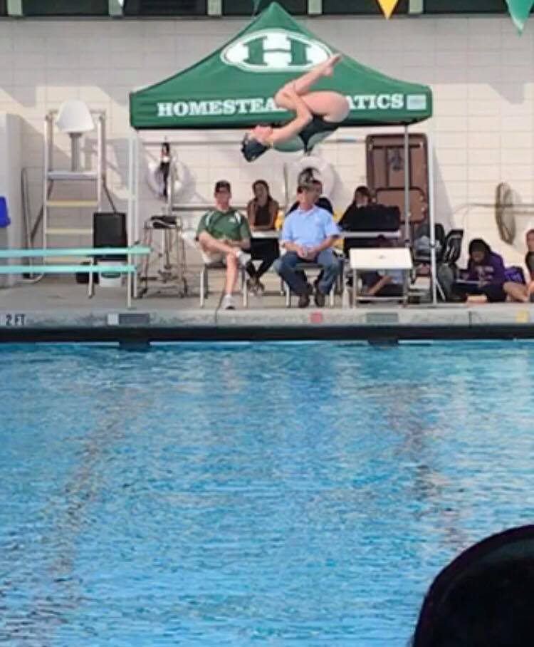 Junior Varsity Captain Anna Dupin completes a flipping dive