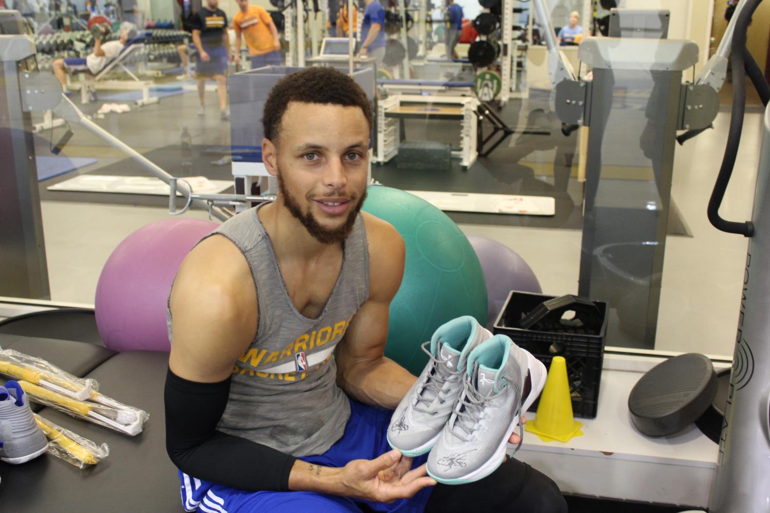 Photo+by+Rachel+Hildebrand.+Curry+with+Nuestro%E2%80%99s+signed+shoes+after+practice+today
