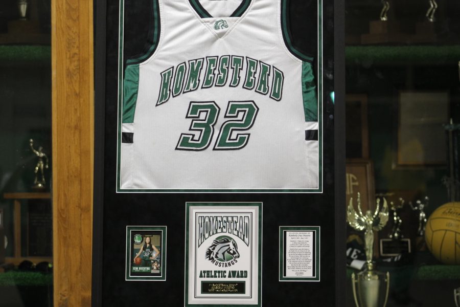 Coach Becky Chiu keeps Kimberly Nuestro’s old jersey in the trophy case as a symbol of honor