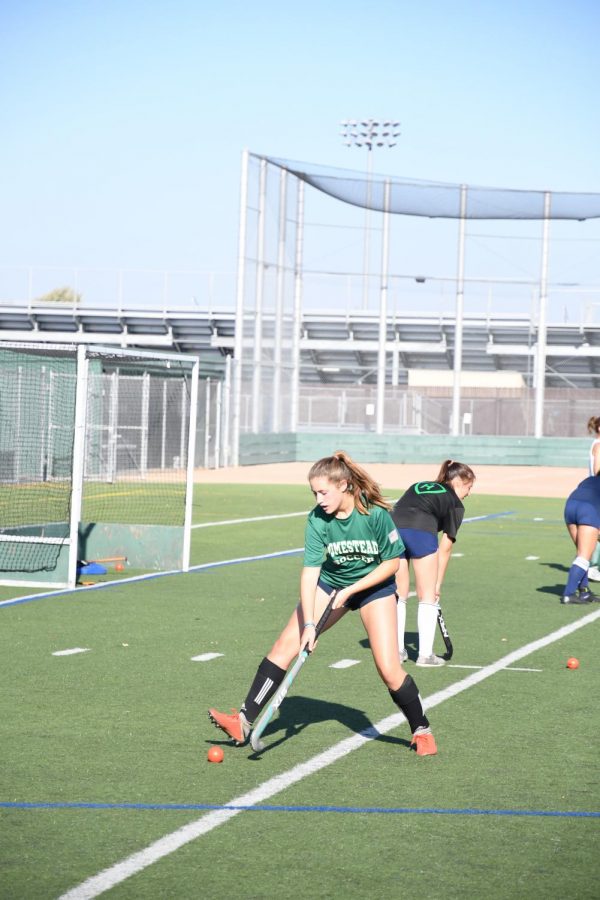 Sophomore Claire Flickner practices on the field with the varsity team wearing her HHS soccer jersey.