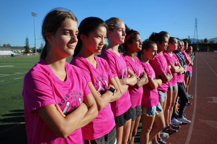 The girls cross country team stands side by side, knowing that their strengths are more than their numbers.