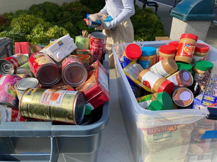 SATURDAY MORNING COLLECTION: members of the Homestead community drop off canned foods, peanut butter and other non-perishable food items.