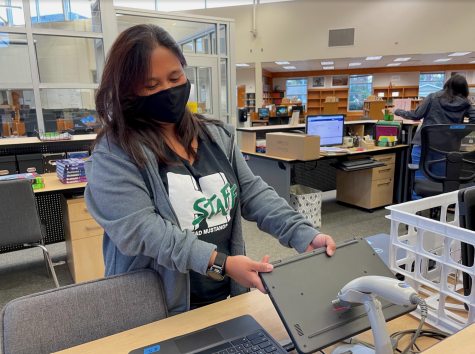 LIVING THE LIBRARIAN LIFE: Verna Grant helps students with their library-related needs, such as with Chromebook distribution.