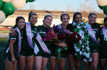 The varsity girls soccer team celebrates the seniors’ last game of the season 