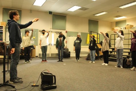 Drum major, senior George Heller performs crescendo exercises with potential candidates during a weekly workshop. 
