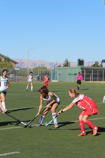 Forward, junior Kiyona Brown defends the ball in a field hockey game. 