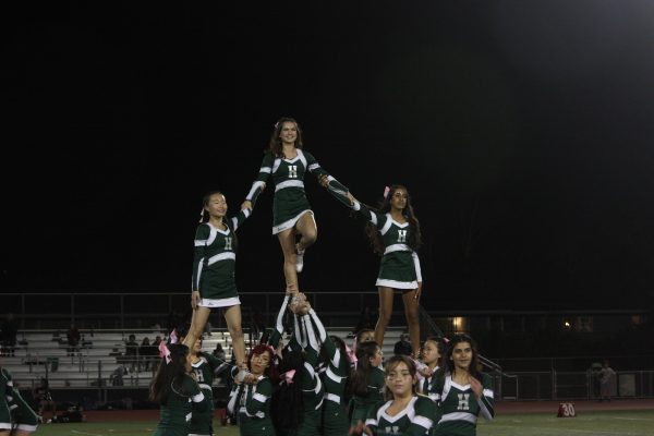 The cheer team performs their routine during the annual Homecoming game on Oct. 13.