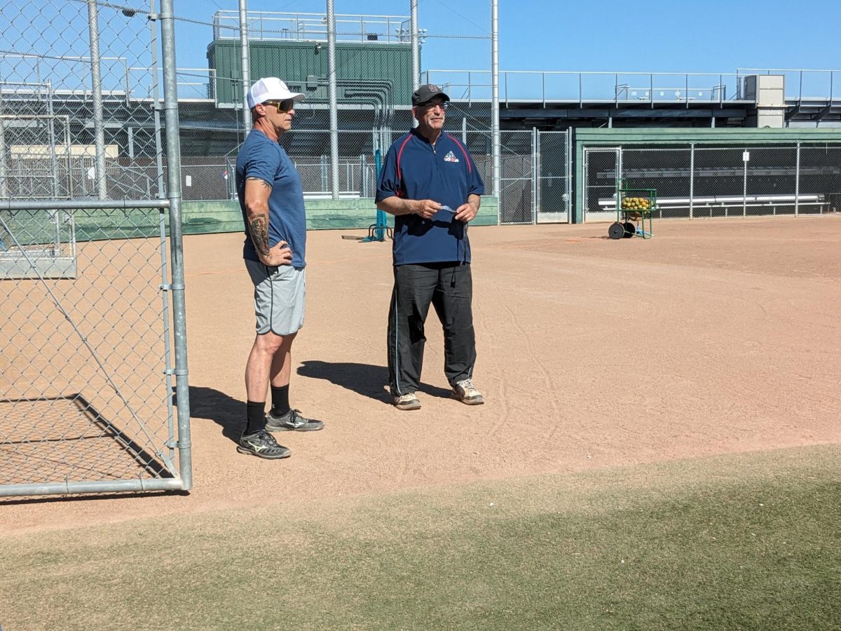 Varsity girls softball coach Chris Caires (right) said he has helped assistant coach Bryan Devert (left) adjust to high school softball coaching.