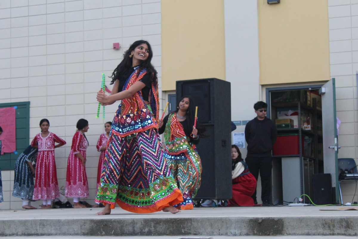 Junior Aarya Patel performs as part of the Raas team during the 2024 Multicultural Night. Props like sticks are often heavy and require great stamina, Jaya Singhal said.